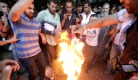 Egyptian protestors burn American flag.jpg 