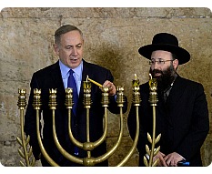 Bibi lighting Hanukah candles