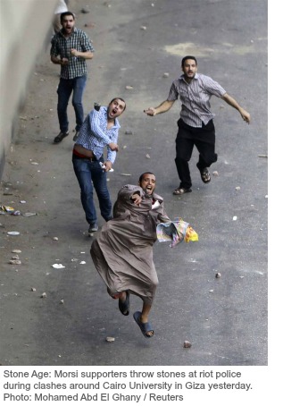 Egypt-Morsi supporters throw stone.jpg