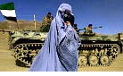 Burqa-wearing woman passes Afghan soldiers.jpg