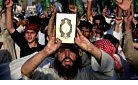 Afghan protestors hold up Koran.jpg