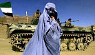 Burqa-wearing woman passes Afghan soldiers.jpg